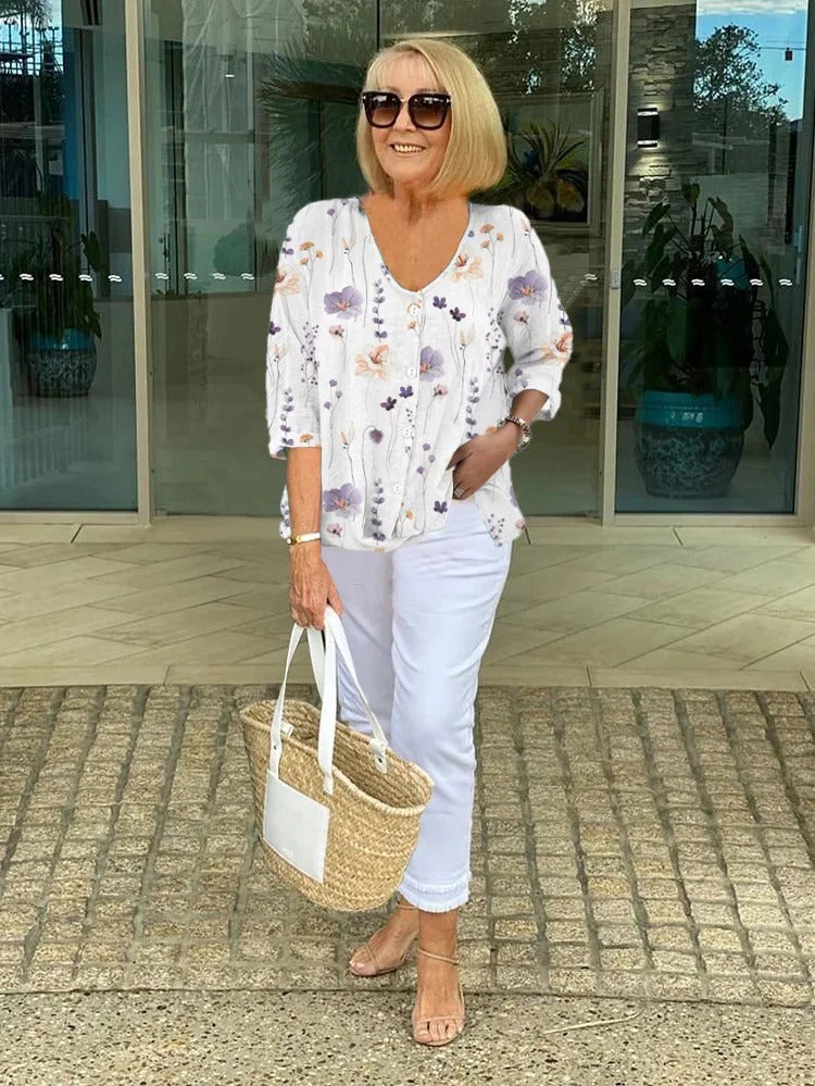 Stylish women's floral blouse featuring an elegant print. Comfortable, lightweight top for spring and summer outfits.