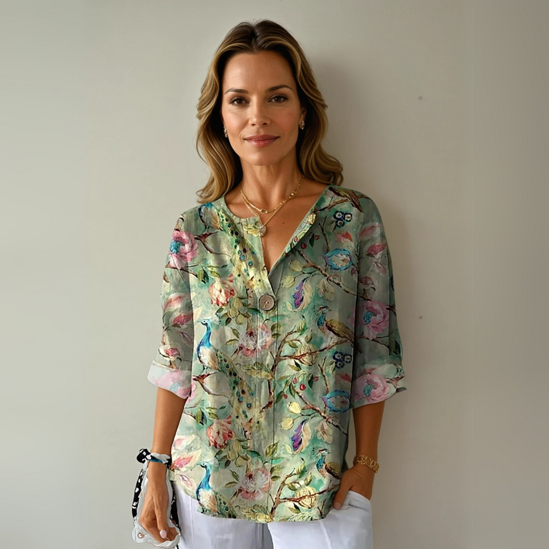 Chic women's blouse with vibrant floral print. Elegant long-sleeve top for fashionable spring/summer wear.