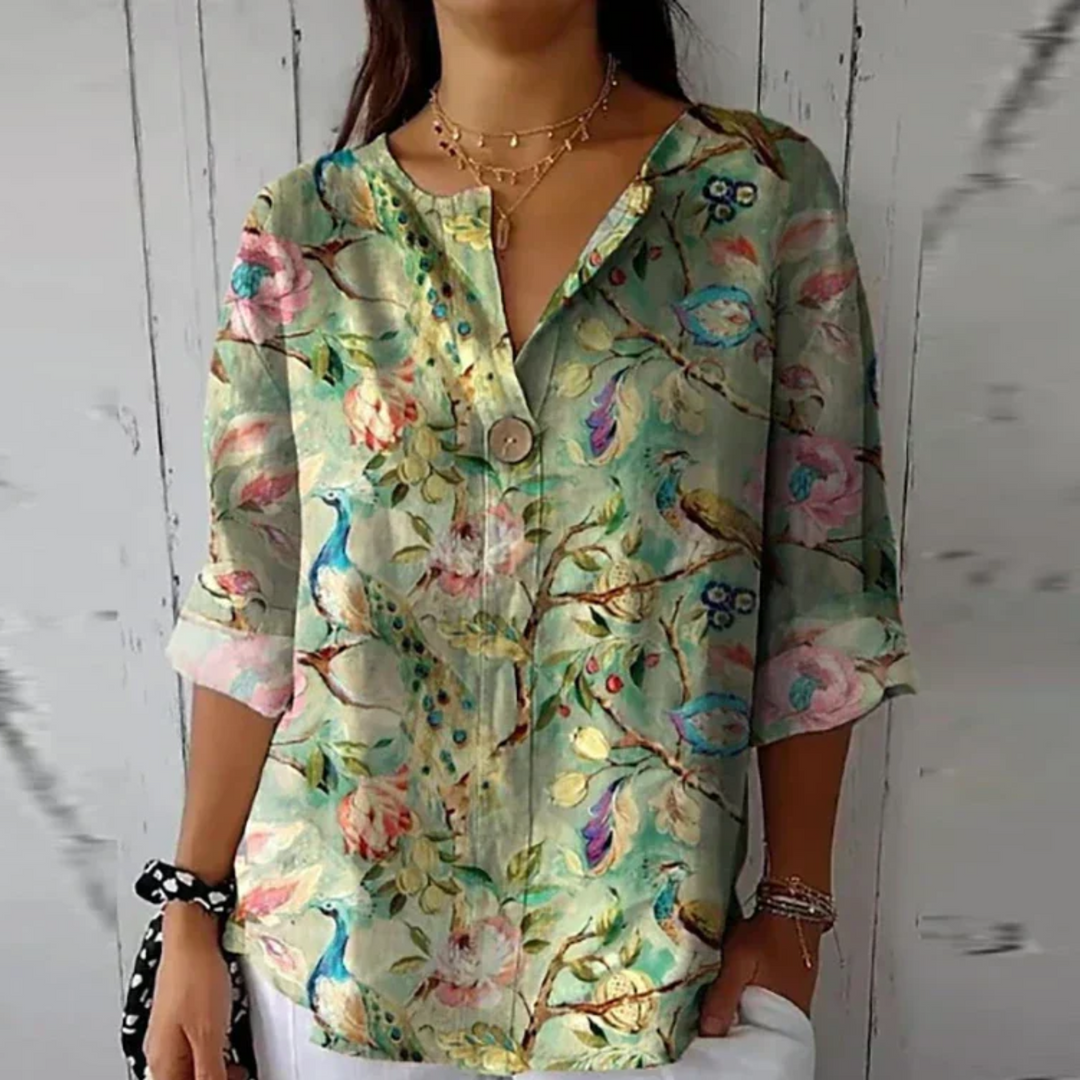 Women's long-sleeve blouse featuring an elegant floral print. Comfortable and chic for spring fashion.