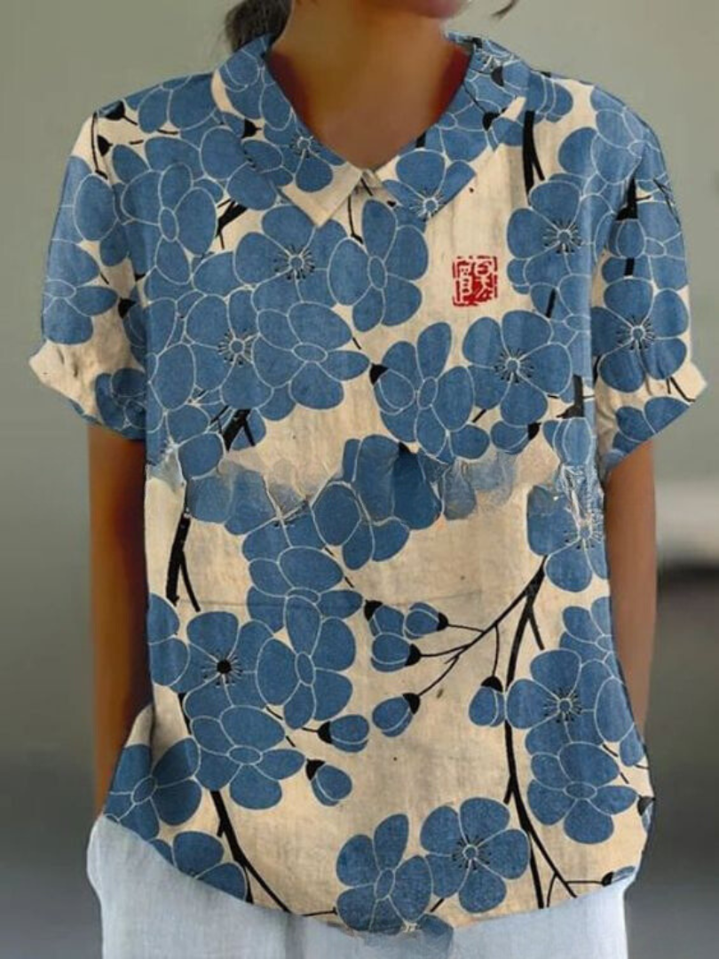 Elegant women's floral print blouse with classic Peter Pan collar & short sleeves, perfect for spring style.
