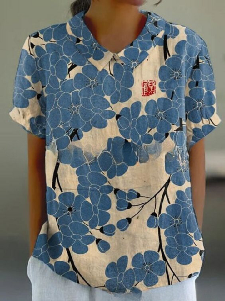 Elegant women's floral print blouse with classic Peter Pan collar & short sleeves, perfect for spring style.