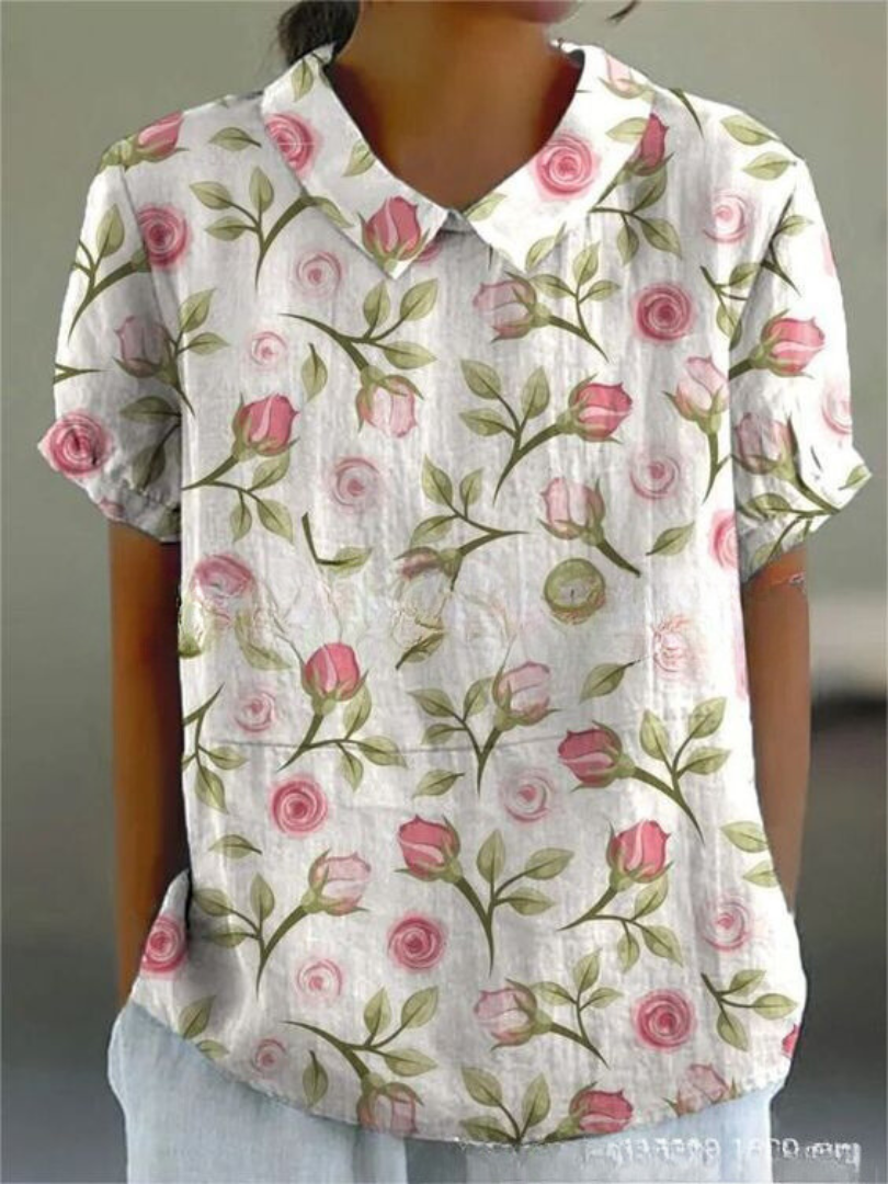 Sophisticated women's short-sleeve floral blouse with a Peter Pan collar, excellent for versatile summer fashion.
