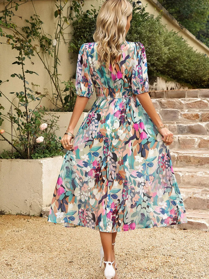 Women's v-neck floral midi dress with elegant puff sleeves, ideal for stylish summer outfits.