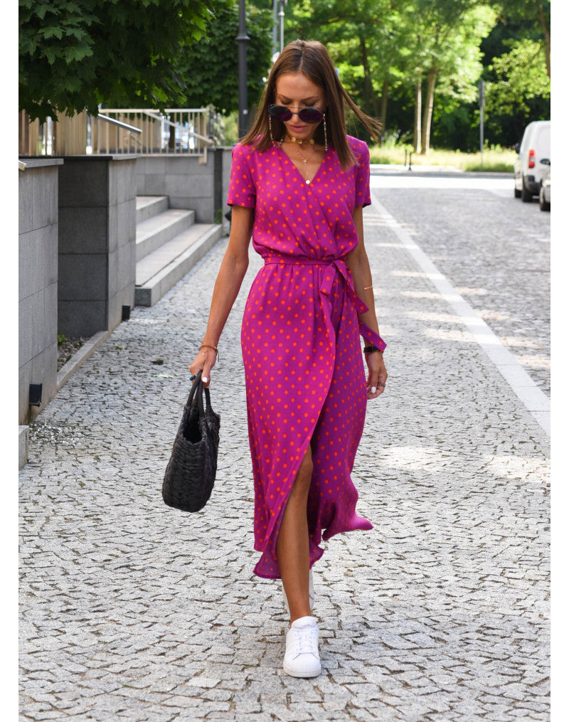 Model wearing a women's floral V-neck midi wrap dress. Shows the flowy fabric & elegant summer aesthetic.
