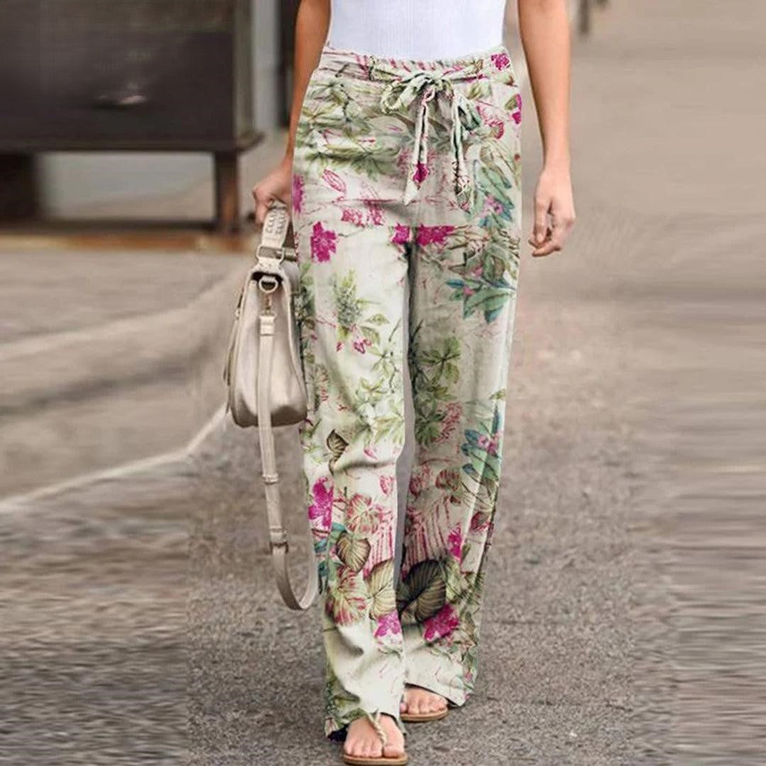 Vibrant floral print women's pants featuring an elegant bow detail, great for summer comfort & style.