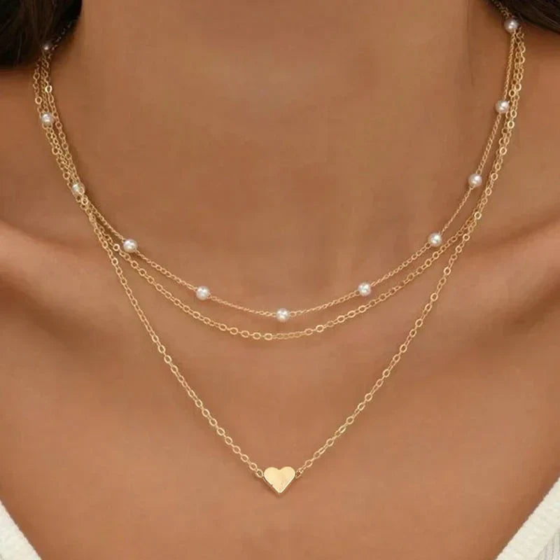 Elegant women's gold layered necklace set with delicate heart charm, a perfect fashion accessory and gift for her.