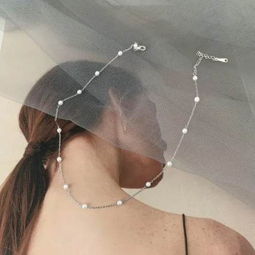 Delicate silver layered pendant necklace set for women, featuring a classic cross charm and adjustable length.