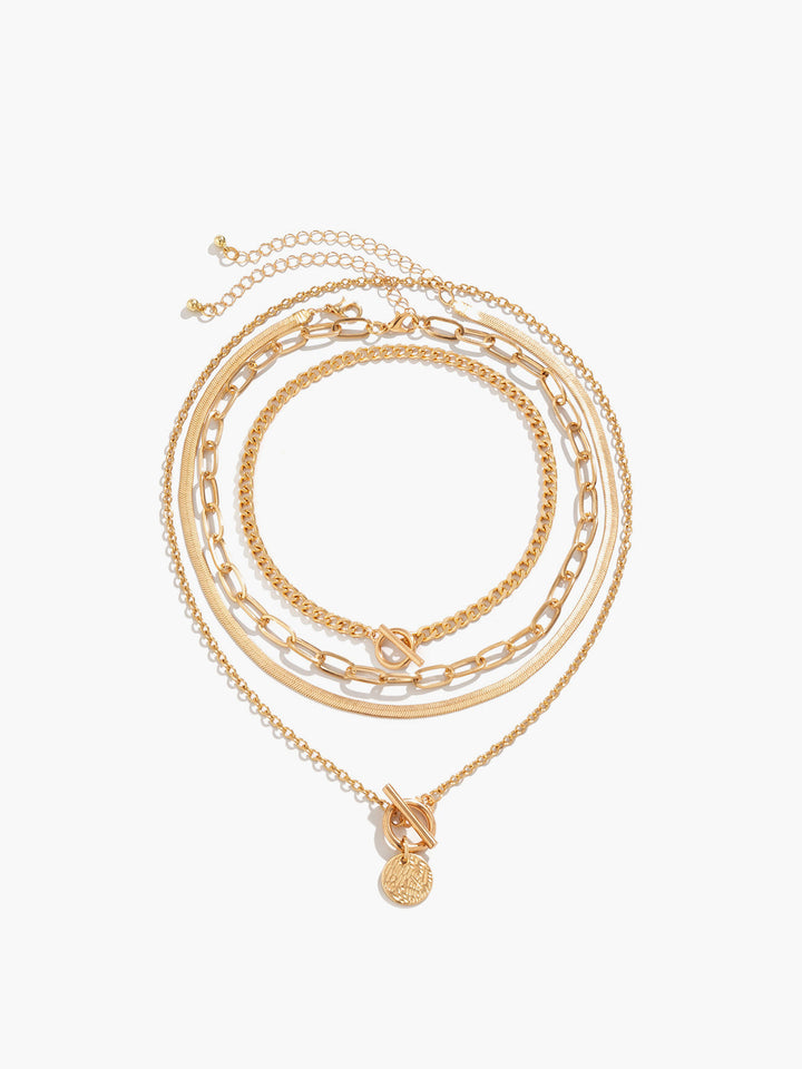 Shining gold layered pendant necklace set for women. Fashionable & elegant jewelry accessory with unique pendants.