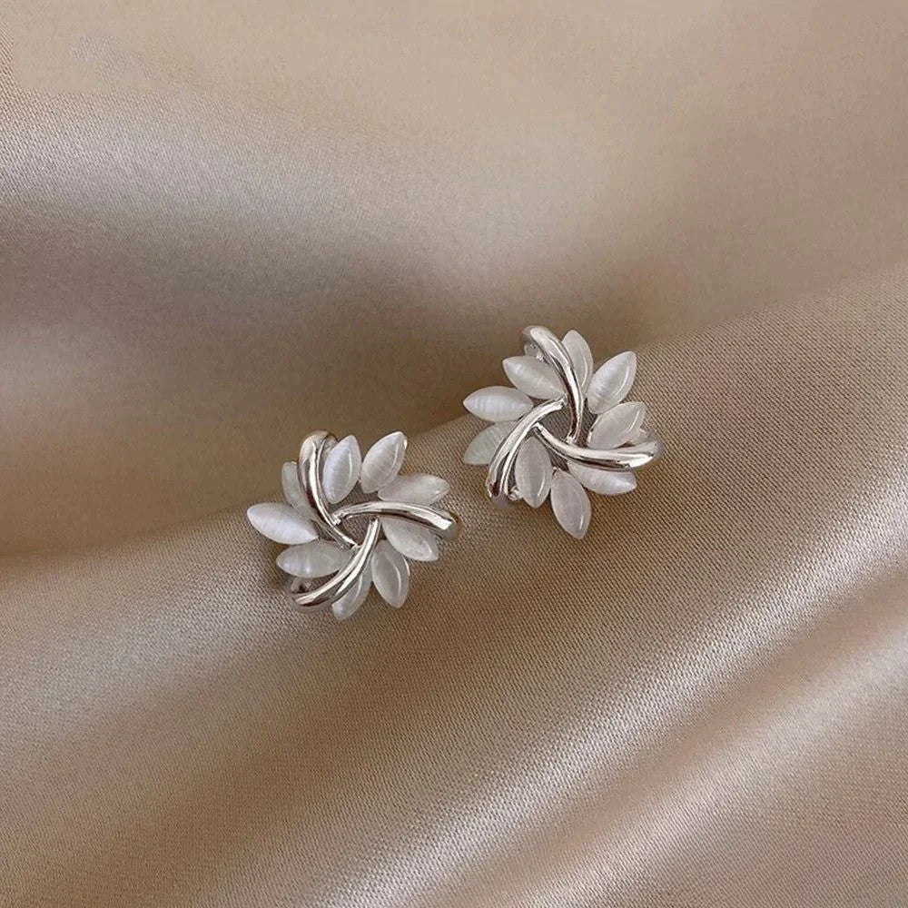 Sophisticated women's silver opal flower dangle earrings. Exquisite floral jewelry, ideal for elegant style.