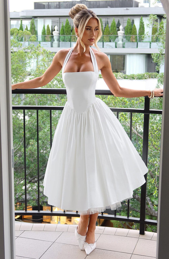 Sophisticated wedding guest midi dress with a halter neckline, ideal for special occasion summer parties.