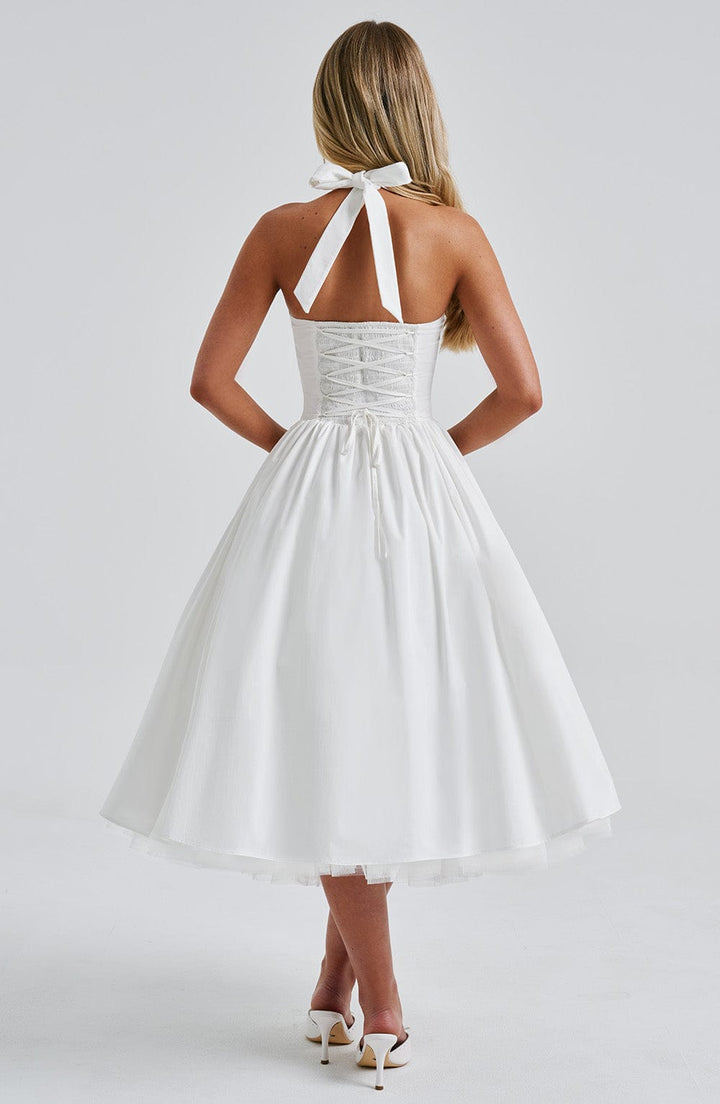 Flattering halter midi dress, elegant and classic, designed for women attending weddings or formal events.