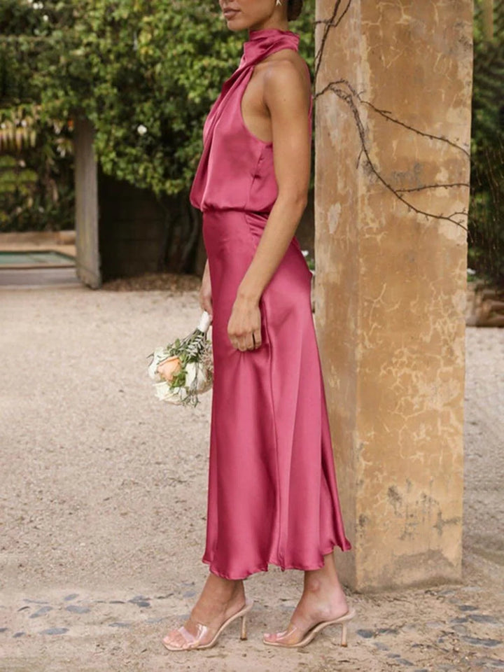 Back view of an elegant women's halter neck midi bridesmaid dress, highlighting the graceful neckline.