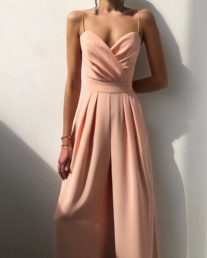 Back view of a women's stylish high-waist spaghetti strap jumpsuit, emphasizing comfortable fit.