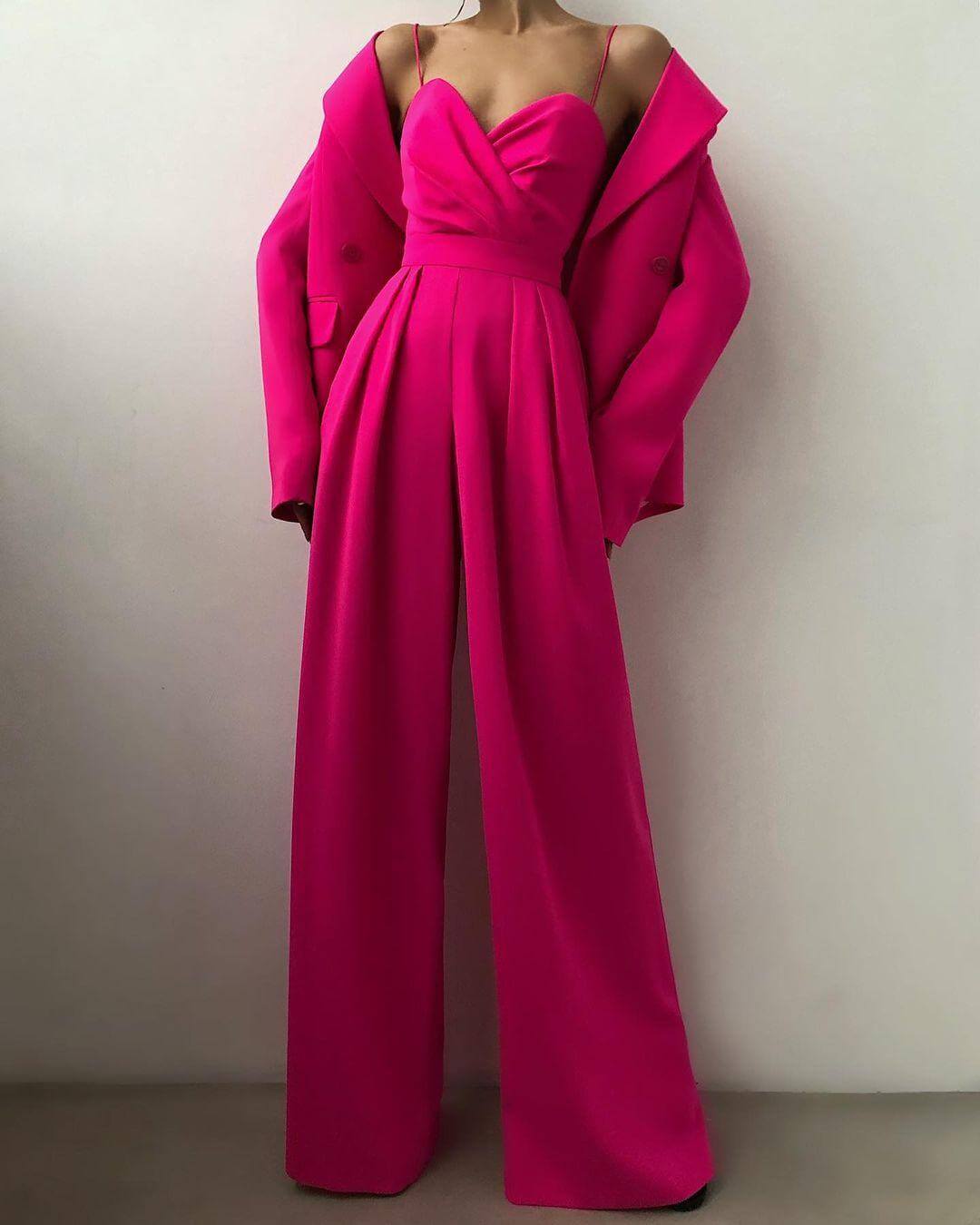 Sophisticated women's high-waist jumpsuit with delicate spaghetti straps. Fashionable summer party outfit.