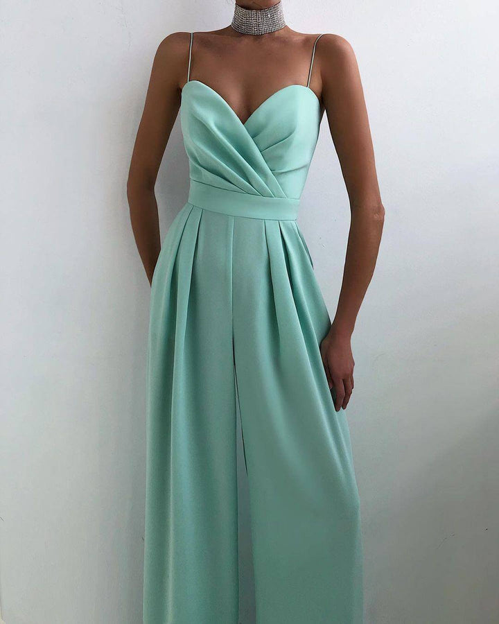 Model wearing an elegant women's high-waisted spaghetti strap jumpsuit, showcasing versatile style.