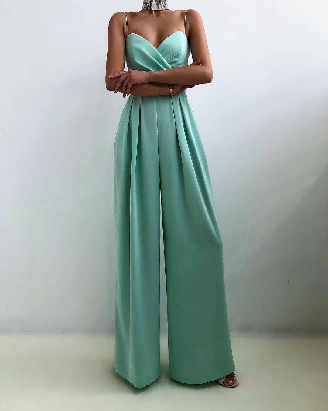 Chic women's jumpsuit with flattering high waist and adjustable spaghetti straps. Comfortable party wear.