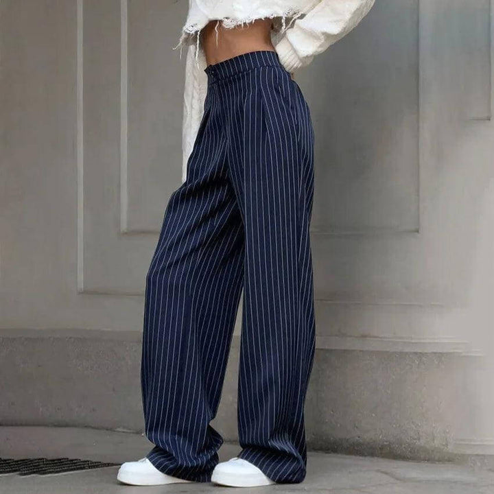 Stylish navy blue high-waisted striped trousers for women, showcasing a flattering fit & modern design. Casual or formal.