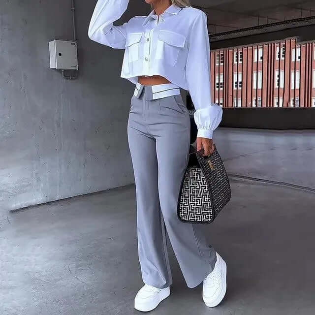 Elegant women's high-waisted wide-leg grey trousers for a comfortable yet stylish look. Perfect for dress or casual wear.