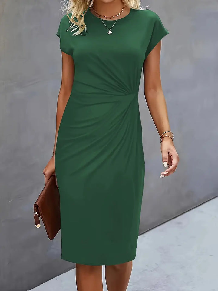 Chic women's spring knee-length sheath dress, featuring a flattering ruched waist and elegant cut.