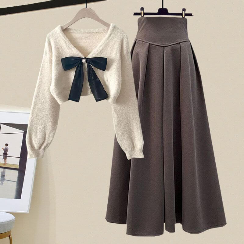 Elegant women's knitted sweater & pleated midi skirt two-piece set. Ideal for fall & winter comfort.