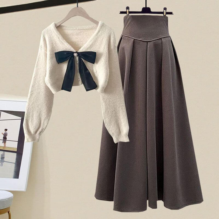 Elegant women's knitted sweater & pleated midi skirt two-piece set. Ideal for fall & winter comfort.