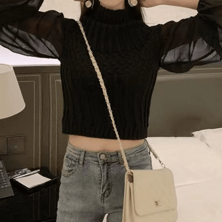 Versatile women's knitted top with sheer sleeves, great for elegant layering.
