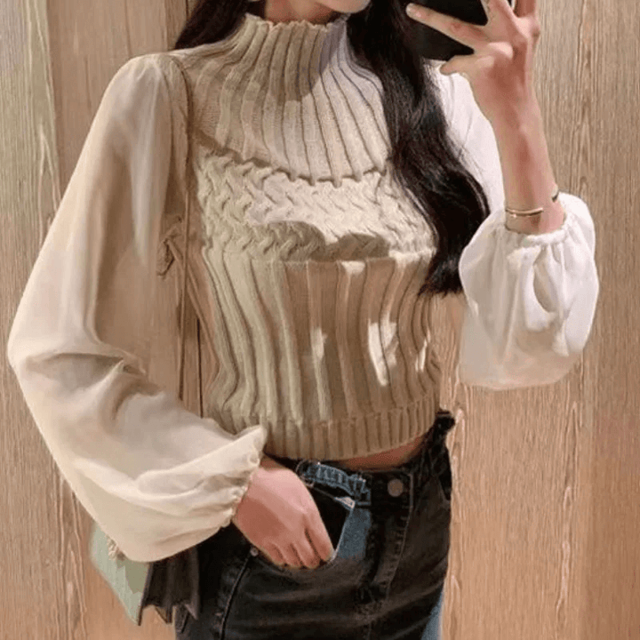 Sophisticated women's knitted vest with sheer sleeves, a timeless autumn fashion piece.