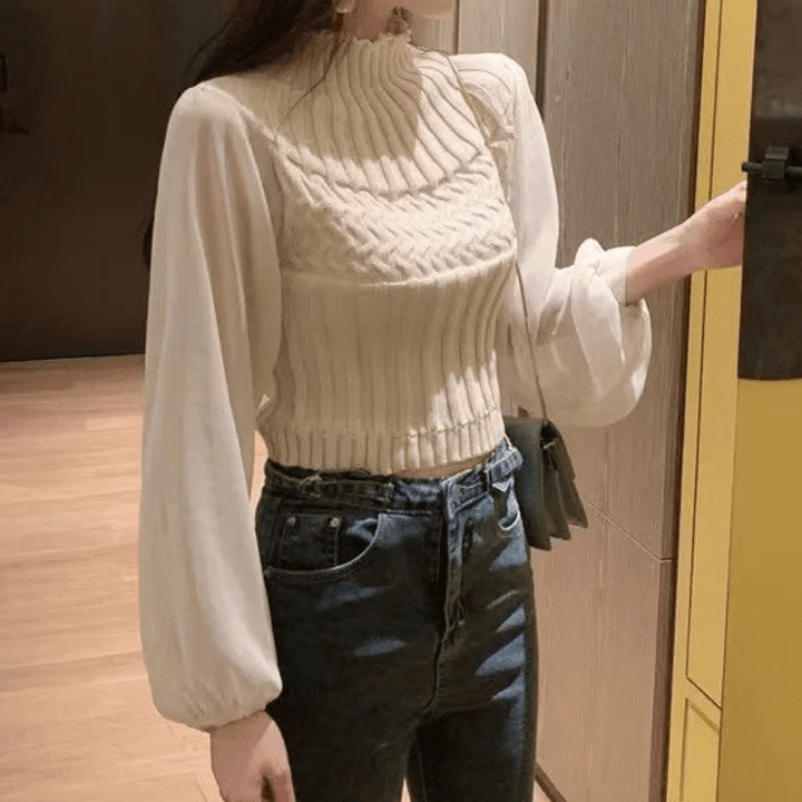 Stylish women's knit vest & sheer sleeves, ideal for elegant winter layering and comfort.