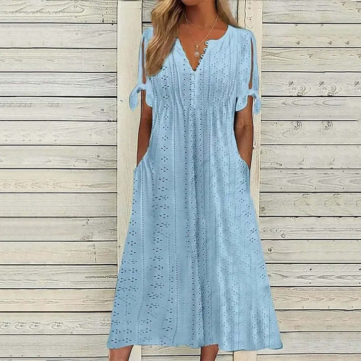 Breathable women's summer midi dress, featuring a flattering V-neck and beautiful lace, ideal for warm weather fashion.