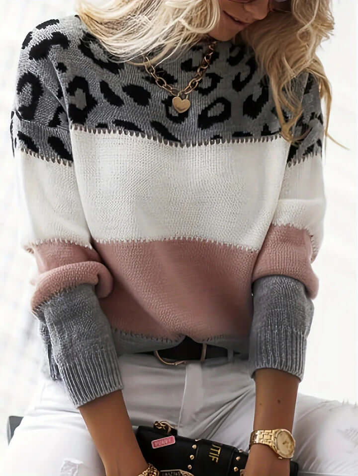 Stylish women's pullover sweater with vibrant leopard print, an elegant long sleeve fashion top.