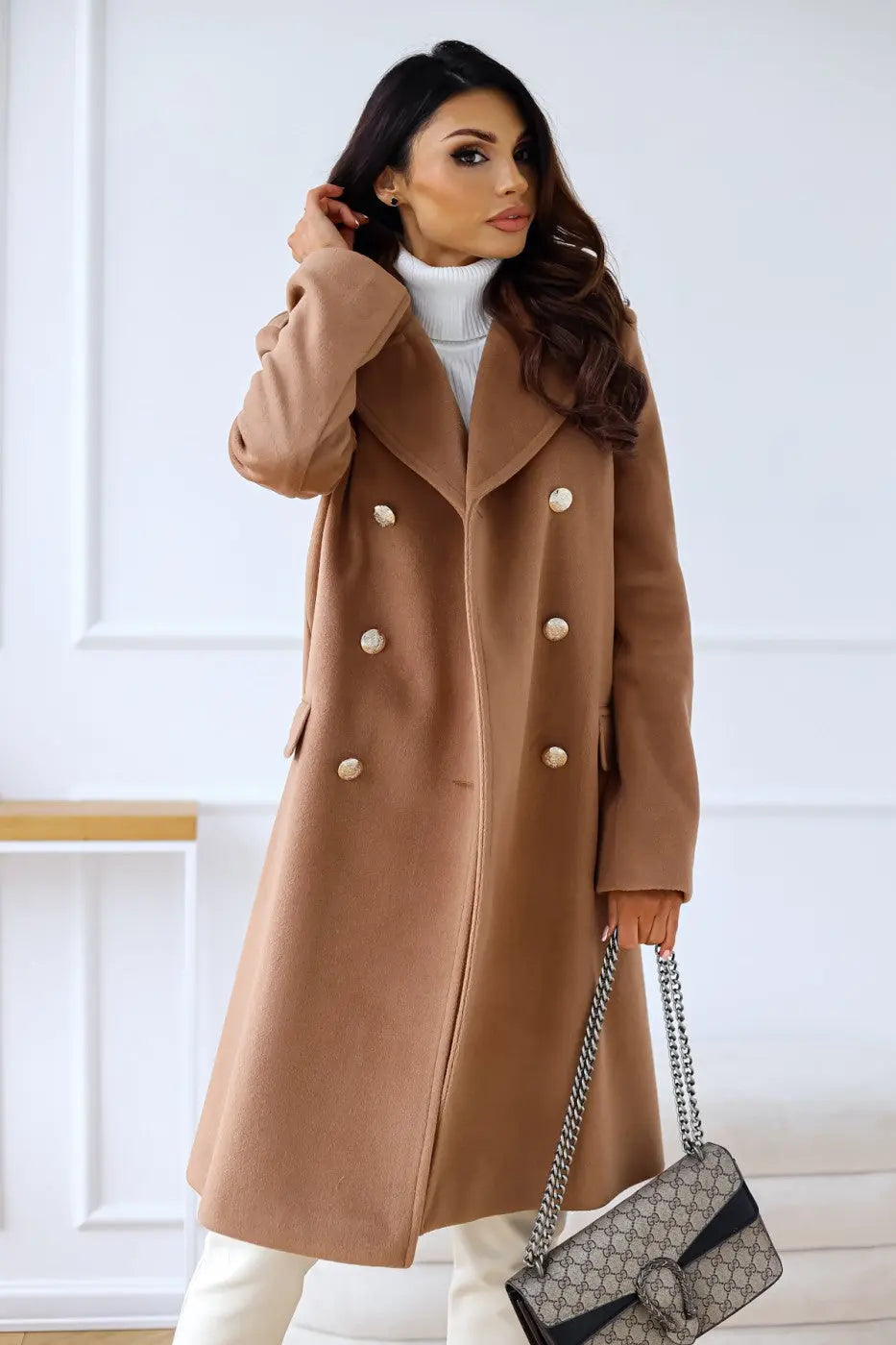 Sleek tailored women's long coat, double-breasted design for an elegant, sophisticated winter silhouette.