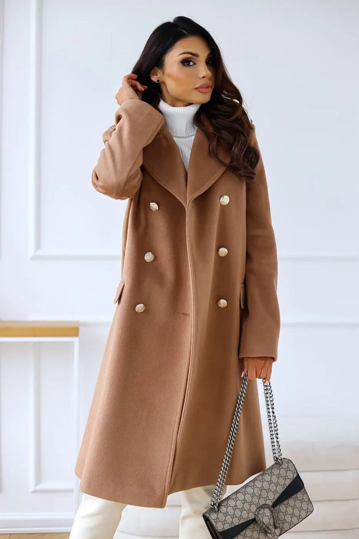 Sleek tailored women's long coat, double-breasted design for an elegant, sophisticated winter silhouette.