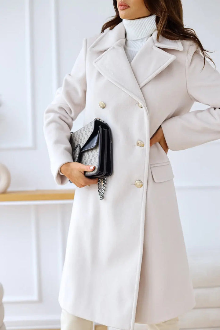 Back view: Elegant women's long double-breasted coat, showcasing classic tailored silhouette and style.