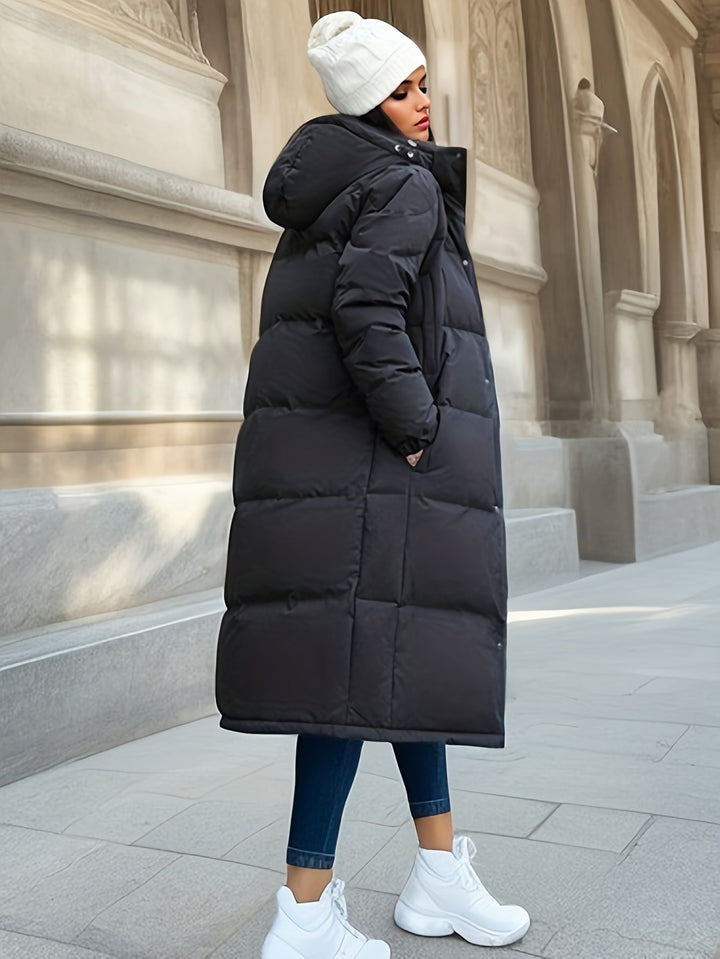 Women's long down puffer coat with hood, providing cozy warmth and an elegant silhouette for winter.