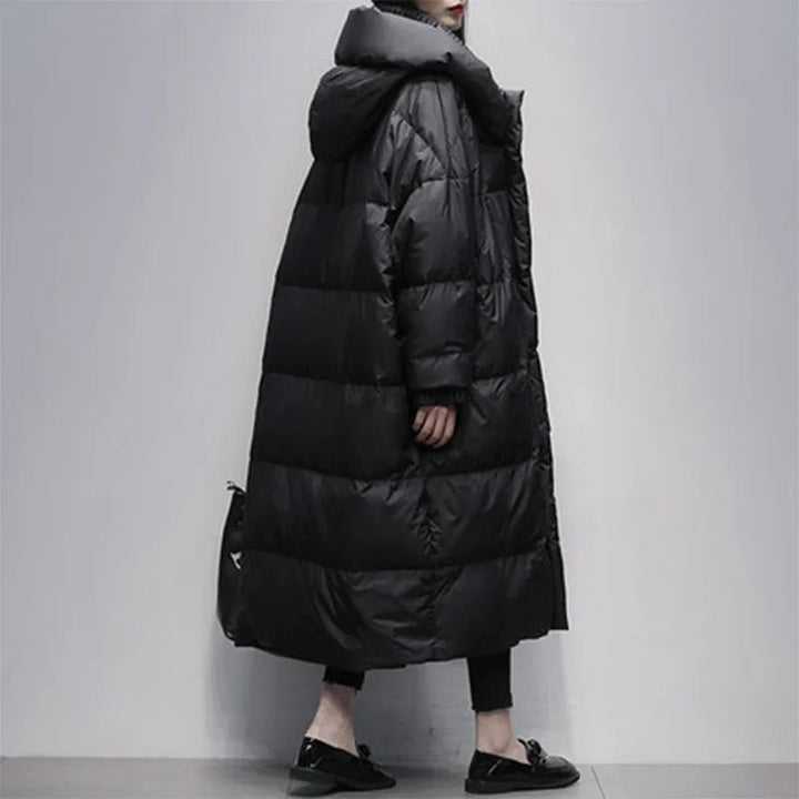 Black Amara long padded winter jacket for women. Stay warm and chic with this elegant cold-weather coat.