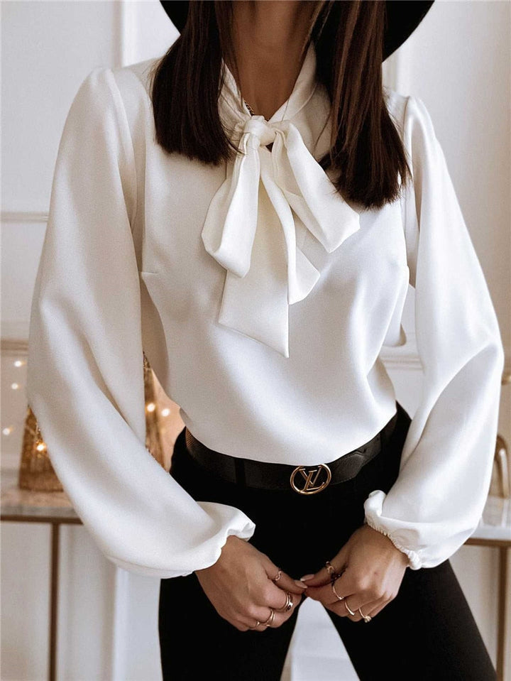 Stylish women's long sleeve blouse featuring a prominent bow, ideal for office fashion & sophisticated looks.