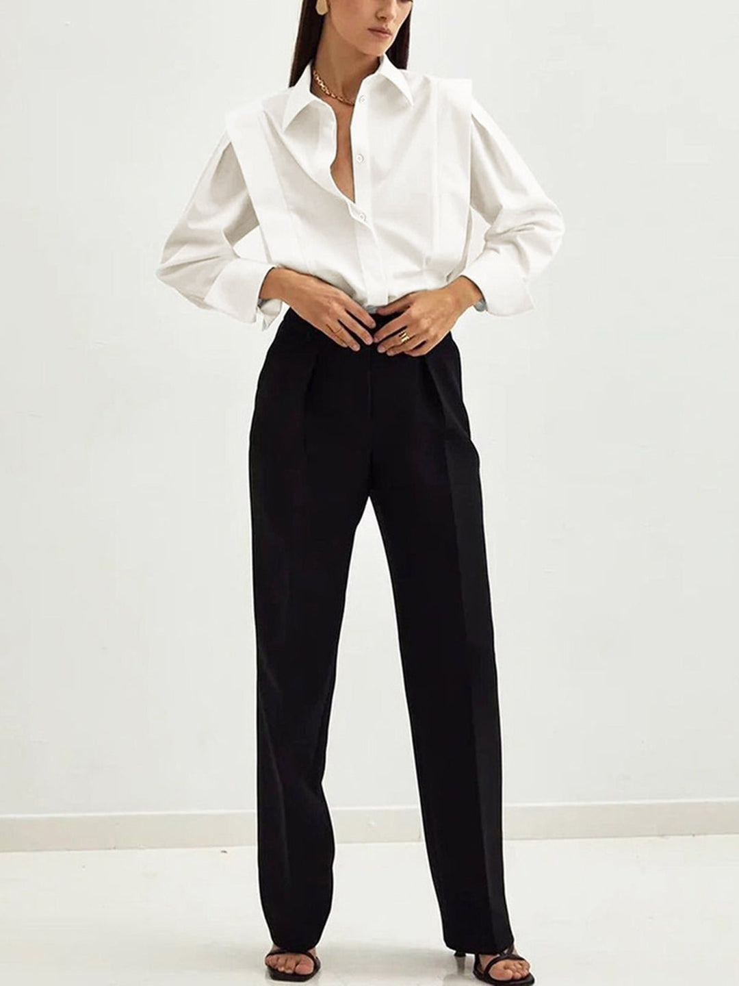 Woman in elegant long-sleeve button-down shirt with square collar. Stylish blouse for office, versatile fashion, or casual chic.