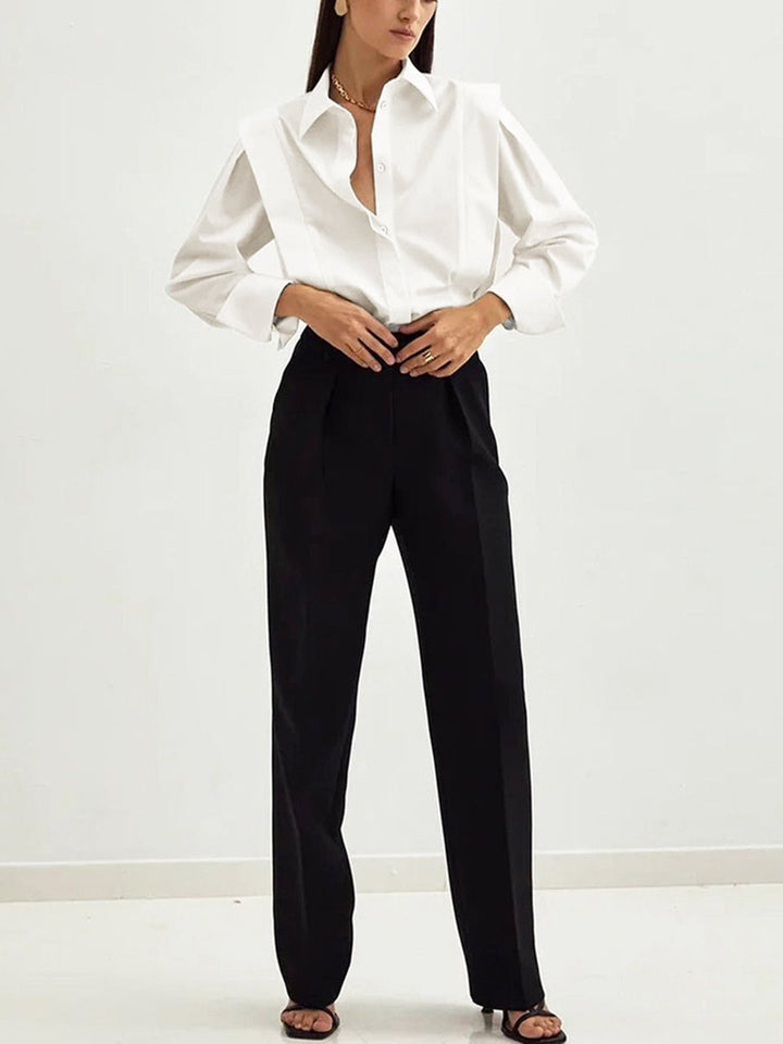 Woman in elegant long-sleeve button-down shirt with square collar. Stylish blouse for office, versatile fashion, or casual chic.