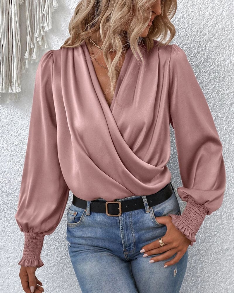 Women's elegant long-sleeve wrap blouse. A chic and versatile top for effortless feminine style, suitable for work.