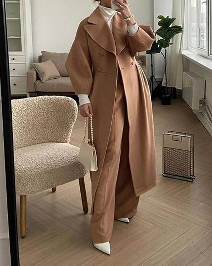 Elegant women's long winter coat with lantern sleeves for a chic, warm look in cold weather.