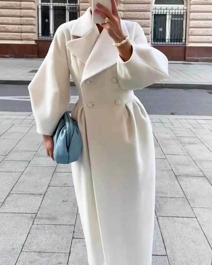 Fashionable women's long coat for winter, elegant outerwear with lantern sleeves.