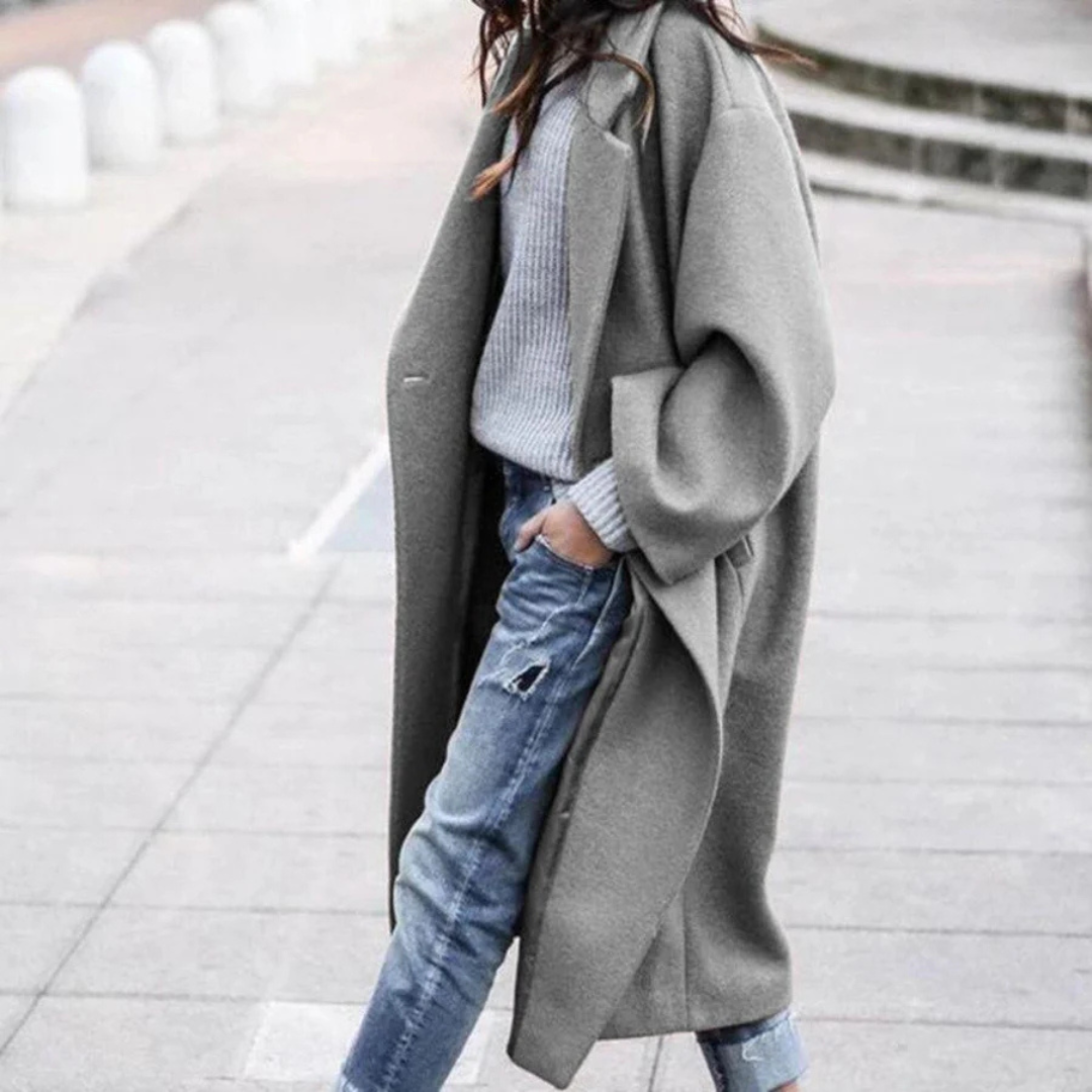 Stylish women's long trench coat, ideal for fall & winter fashion, offering elegant outerwear and warmth.