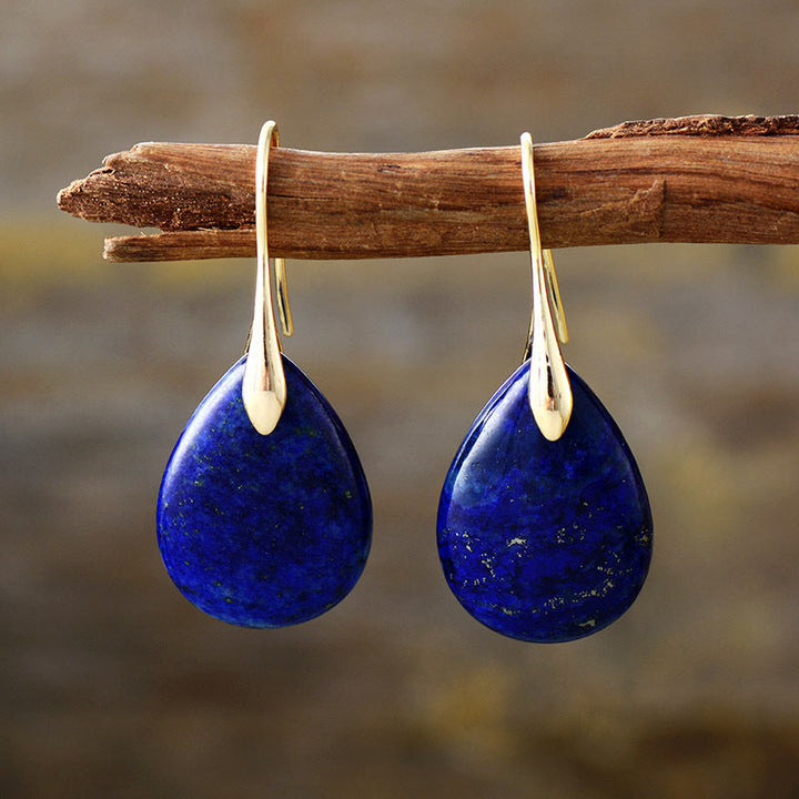 Fashionable natural stone drop earrings for women. Unique dangle teardrop design with elegant raw stone texture.