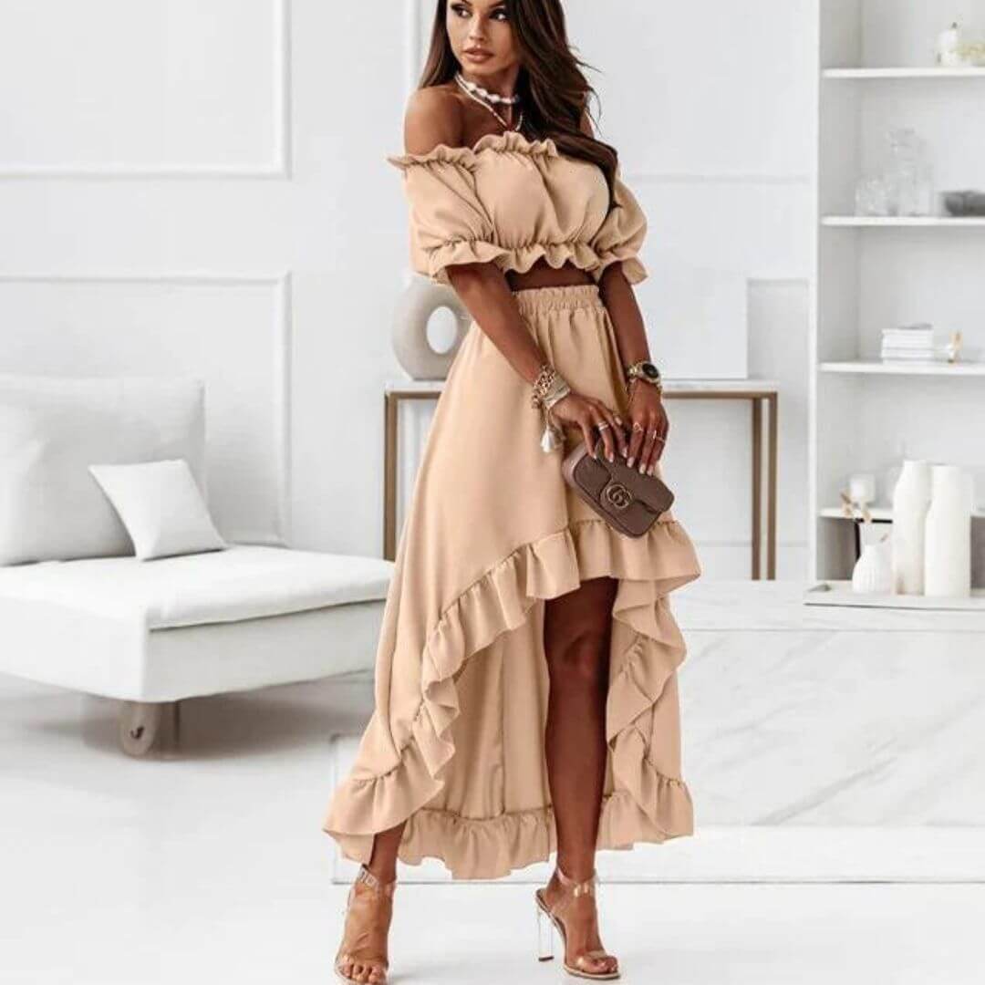 Stylish women's two-piece outfit: off-shoulder frill crop top and flowing high-low skirt. Versatile summer fashion.