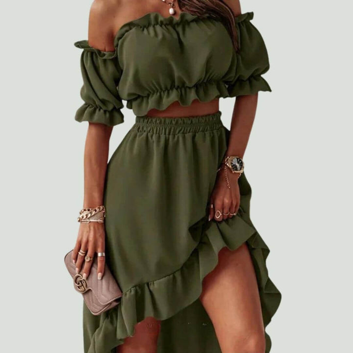 Fashionable women's set featuring a frill off-shoulder crop top and a dramatic high-low skirt. Elegant women's clothing.