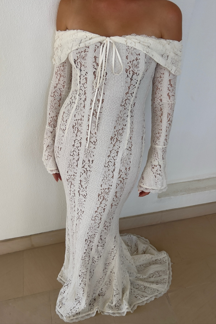 Fashionable women's off-shoulder long white maxi dress, an elegant party or evening gown.