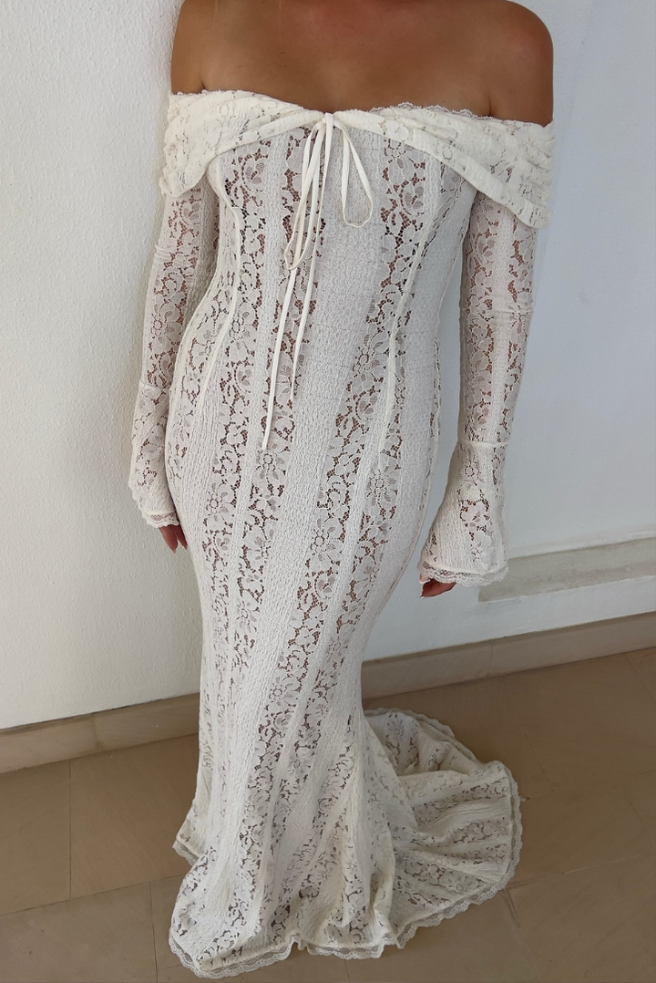 Fashionable women's off-shoulder long white maxi dress, an elegant party or evening gown.