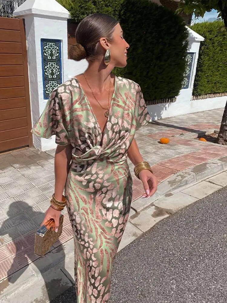 Flowing satin midi dress for women featuring a delicate floral print, V-neck, and short sleeves, ideal for elegant party wear.
