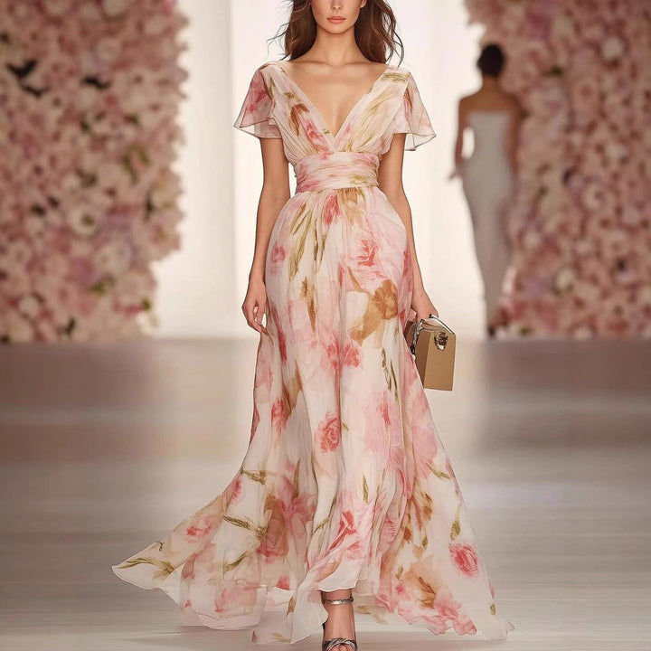 Elegant women's pink floral V-neck fit & flare maxi dress with flutter sleeves, perfect for summer occasions.