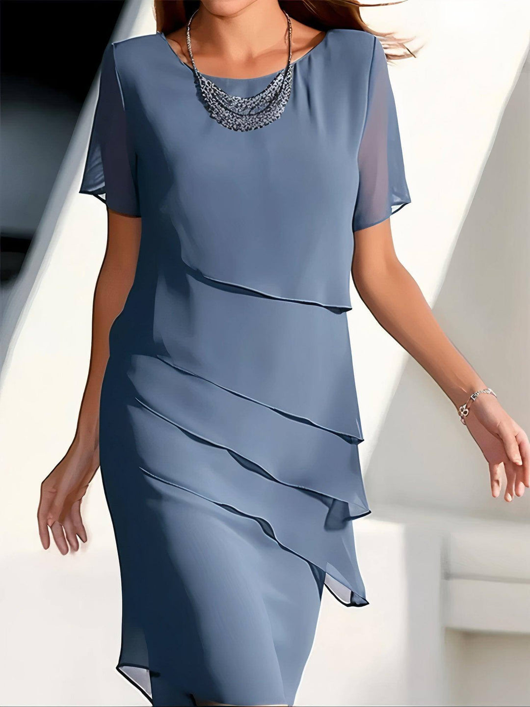Chic women's midi dress featuring delicate pleats and a flowy chiffon fabric. Ideal for summer events.